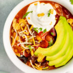 This 3 bean vegetarian chili is a meatless dinner option that’s perfect for meal prep, or a healthy yet filling weeknight meal that’s also dairy-free and gluten-free. It’s incredibly easy to make, only has a 30-minute cook time and is made with pantry staple canned ingredients, so throwing it together on busy days is quick and simple! It’s also a great chili recipe for a chili bar at a family event or football party, because everyone can add their own toppings! #veganchili #beanchili #meatlessrecipes #glutenfree #dairyfreerecipes #slowcookerchili