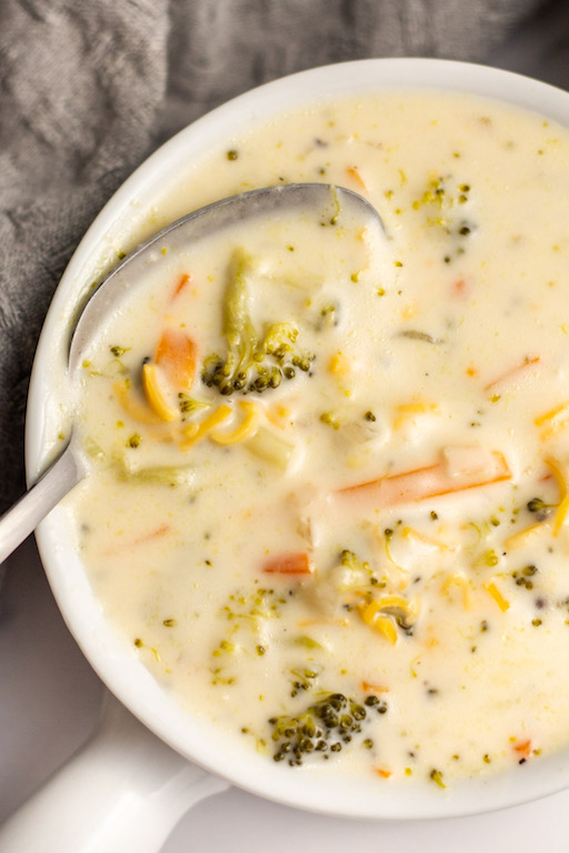 This easy instant pot broccoli cheese soup recipe only takes about a half hour, has hearty vegetables to go along with the broccoli like onion and carrots, and tastes even better than you favorite restaurant's version. It's a gluten-free and meatless soup recipe that's perfect for a chilly day or pairing with a salad or sandwich! This broccoli cheese soup also makes great leftovers, so you can enjoy it all week! #instantpotsoup #broccolicheesesoup #broccolirecipes #meatless #instantpotsoup