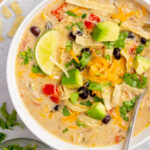 This easy slow cooker Mexican corn chicken soup (or chowder!) is so simple to make, and relies mostly on pantry ingredients! Cooking with pantry staples makes this a really budget-friendly chicken crock pot recipe. It's full of vegetables, black beans, chicken thighs so it's a great gluten-free soup option! This corn chicken soup is flavorful, perfectly spiced, and perfect for an easy weeknight dinner or meal prep recipe. #slowcookerchickensoup #mexicancornsoup #glutenfreeslowcooker #crockpot #slowcookersoup