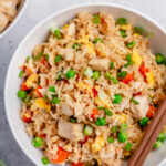 Instant pot chicken fried rice is the perfect one pot recipe for a fast and easy weeknight meal with no mess. It has just a few ingredients and is naturally gluten free and dairy free. You can easily swap out the chicken for extra veggies to make it vegetarian. Look no further for a healthy, satisfying, alternative to take out! #instantpotchicken #onepotmeals #chickenfriedrice