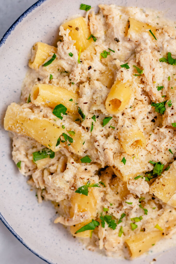 Slow cooker chicken Alfredo pasta is a satisfying meal any day of the week. Made even better with an easy homemade Alfredo sauce! It's easy to make gluten free or vegetarian, and made with only a few simple ingredients you likely have at home already. Let your crock pot do the work and add this chicken alfredo pasta to your weeknight meal rotation! #chickenalfredo #alfredopasta #slowcookerpasta #homemadealfredo