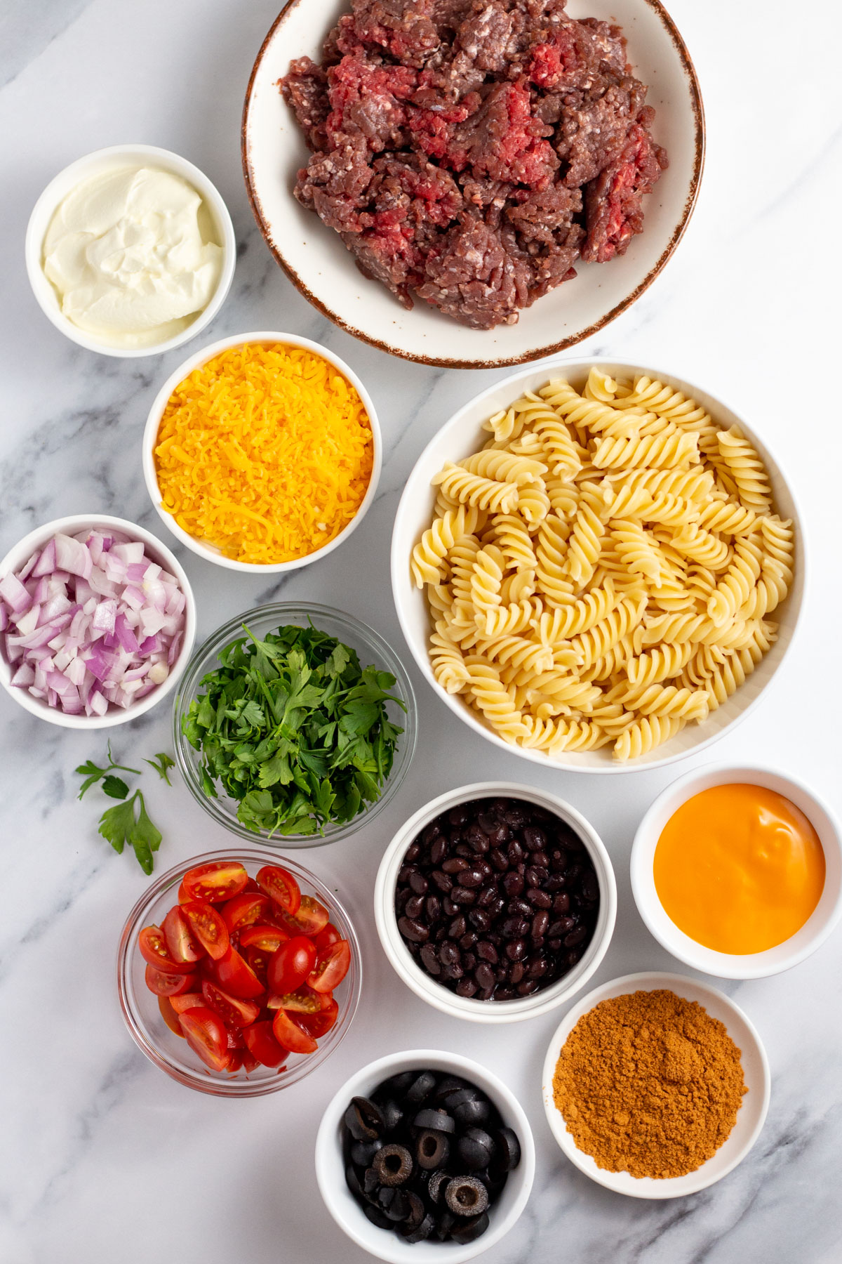 This quick and easy salad is ready in under thirty minutes and will definitely hit the spot! It's full of all the fresh flavors of taco night packed into a simple, delicious, pasta salad. The taco pasta salad is a breeze to make gluten free and is a perfect side for any meal, potluck, or family gathering. #tacosalad #pastasalad #glutenfree