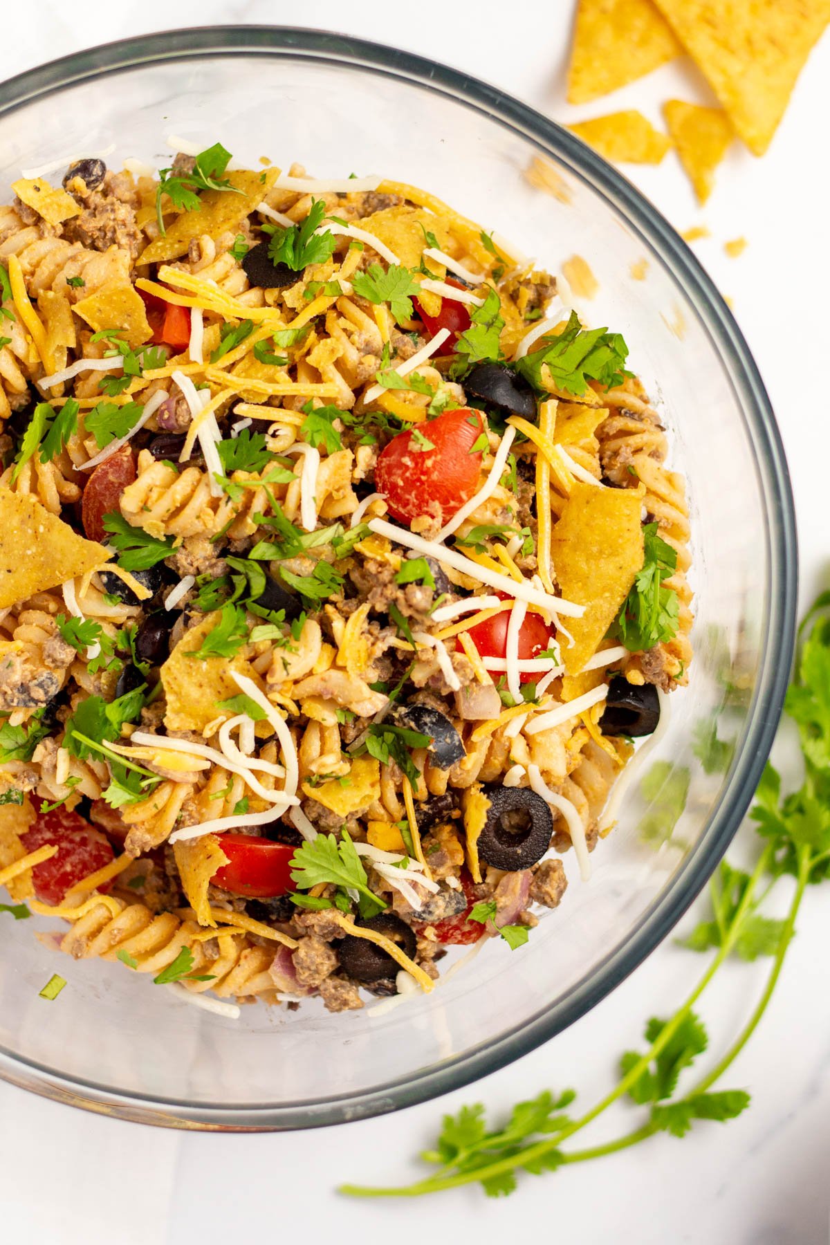 This quick and easy salad is ready in under thirty minutes and will definitely hit the spot! It's full of all the fresh flavors of taco night packed into a simple, delicious, pasta salad. The taco pasta salad is a breeze to make gluten free and is a perfect side for any meal, potluck, or family gathering. #tacosalad #pastasalad #glutenfree