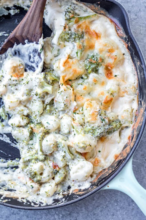 This cheesy broccoli gnocchi skillet is a super easy meatless recipe that can be made vegetarian and gluten-free. The pillowy gnocchi skillet, made in under 30 minutes, is a satisfying dish that will have even the kids eating their broccoli and wanting more. #meatlessrecipes #gnocchiskillet #broccolignocchi #meatlessdinner