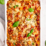 This easy meatless baked ziti is made with 3 cheeses layered in one delicious pasta dish. The ricotta, mozzarella, and parmesan melt together with the red sauce and ziti noodles for a satisfying vegetarian dinner that can easily be made gluten free. Baked in the oven in a quick 35 minutes, with only a few ingredients you likely already have in the pantry; you can't go wrong! #easymeatlessbakedziti #3cheesebakedziti #glutenfreebakedziti