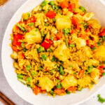 This pineapple curry fried rice is both easy and fast. It's naturally gluten free, dairy free, and completely vegan. The flavors of the pineapple and curry combine with the cilantro and green onion in one pan for a healthy and delicious weeknight meal with minimal cleanup. This one checks all the boxes! #whole30recipes #glutenfree #dairyfree #healthyrecipes #whole30dinner