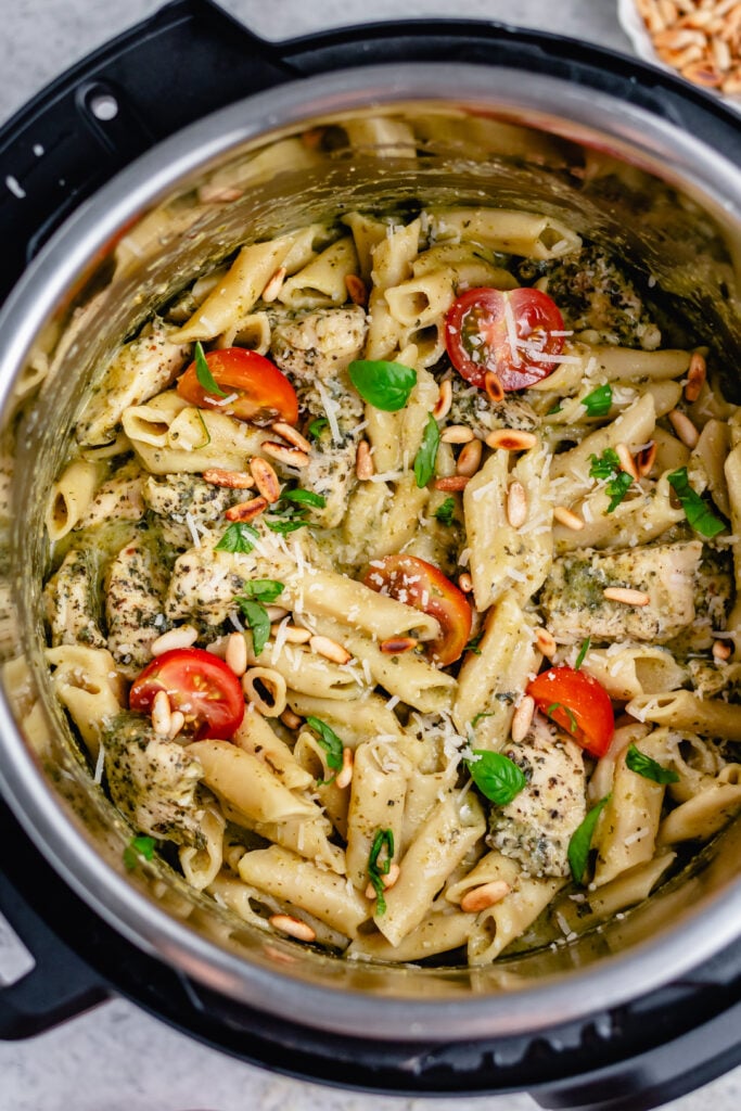 Pesto chicken pasta in the instant pot is the best way to do it. It's super easy and is ready in under 20 minutes. The fresh flavors of the pesto and Italian seasoned chicken combine perfectly in this recipe that's easy to make both gluten free and dairy free. Make this pesto chicken pasta for dinner or meal prep delicious lunches for the week ahead! #instantpotrecipes #healthyrecipes #healthydinnerrecipes #chickenrecipes #chickepesto