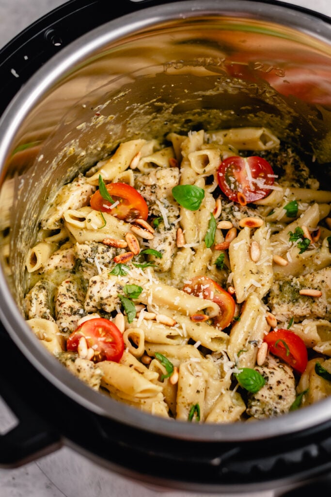 Pesto chicken pasta in the instant pot is the best way to do it. It's super easy and is ready in under 20 minutes. The fresh flavors of the pesto and Italian seasoned chicken combine perfectly in this recipe that's easy to make both gluten free and dairy free. Make this pesto chicken pasta for dinner or meal prep delicious lunches for the week ahead! #instantpotrecipes #healthyrecipes #healthydinnerrecipes #chickenrecipes #chickepesto