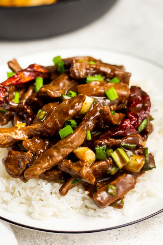 This hot and spicy beef recipe is a healthy, family friendly version of a classic recipe. It's simple to make gluten free and is perfect for both dinner and meal prep. The recipe is ready in 20 minutes and uses only one pan and just a few staple ingredients. Skip the take out line and make your own hot and spicy beef! #30minutemeals #glutenfreerecipes #onepanmeals #beefdinnerrecipes #skilletrecipes