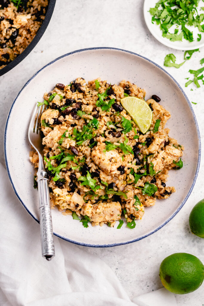 This salsa verde chicken skillet recipe is fresh and flavorful and can be made in twenty minutes from start to finish. It's both gluten free and dairy free and uses only the one skillet so cleanup is a snap. The salsa verde and lime juice play into a not-too-spicy mix of flavors that accent the chicken and rice fantastically. #glutenfreerecipes #dairyfreerecipes #glutenfreedairyfreerecipes #healthychickenrecipes #chickenrecipes #quickdinnerrecipes