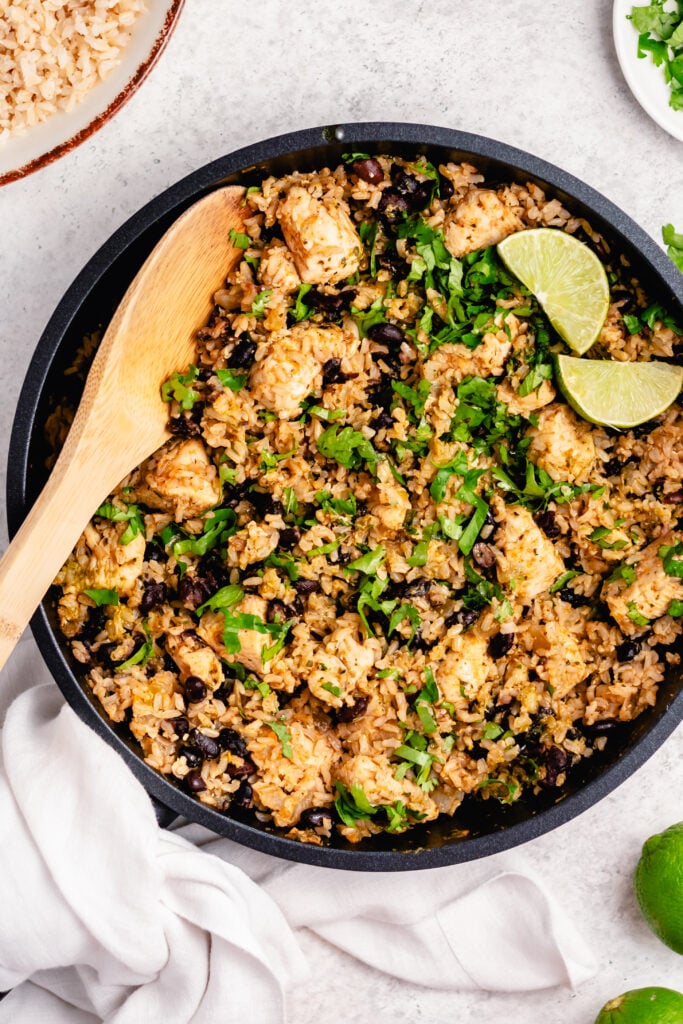 This salsa verde chicken skillet recipe is fresh and flavorful and can be made in twenty minutes from start to finish. It's both gluten free and dairy free and uses only the one skillet so cleanup is a snap. The salsa verde and lime juice play into a not-too-spicy mix of flavors that accent the chicken and rice fantastically. #glutenfreerecipes #dairyfreerecipes #glutenfreedairyfreerecipes #healthychickenrecipes #chickenrecipes #quickdinnerrecipes