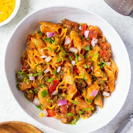 Instant Pot enchilada pasta is a tasty and versatile recipe to get even more use out of your pressure cooker. It's a super easy recipe to make gluten free or dairy free and can be made on the stovetop if you wish as well. You get all the flavors of enchiladas that you love with the speed and convenience of the Instant Pot. #glutenfreerecipes #dairyfreerecipes #glutenfreedairyfreerecipes #healthydinnerrecipes #beefrecipes #enchilada